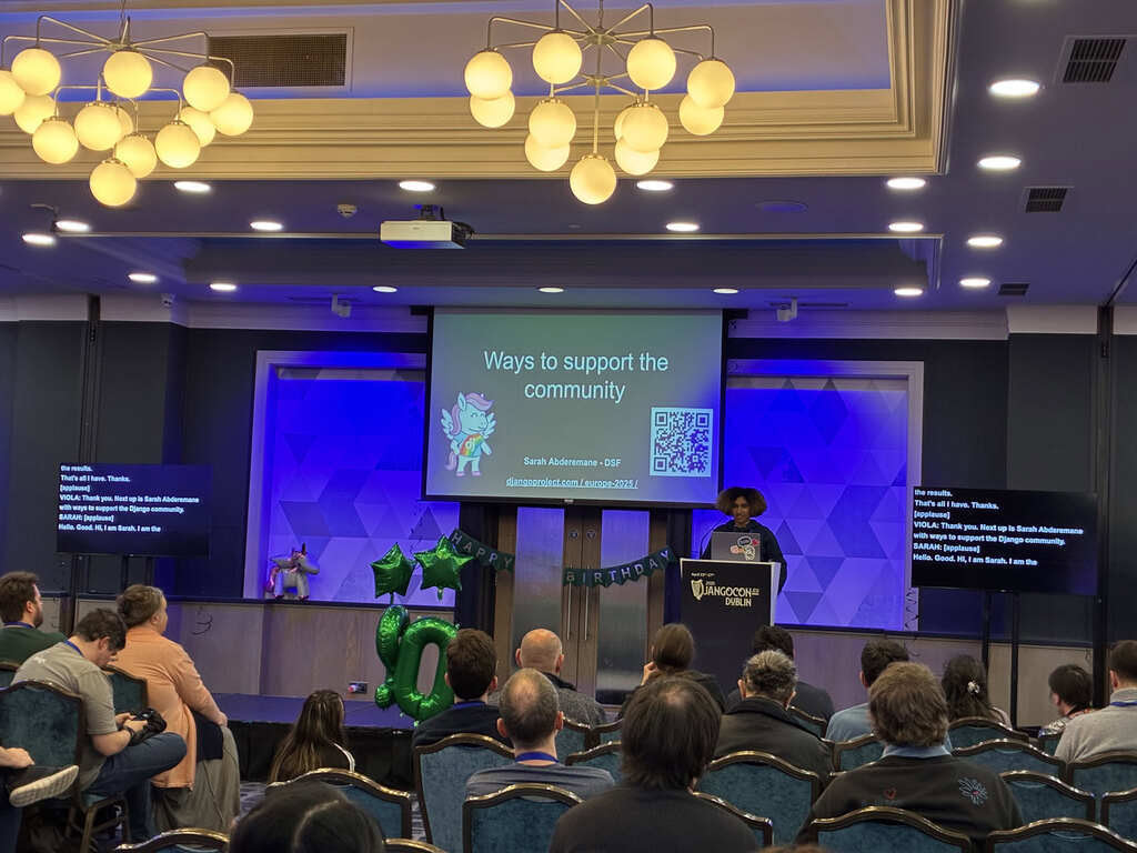 Sarah Abderemane on stage, with a slide titled 'Ways to support the community'