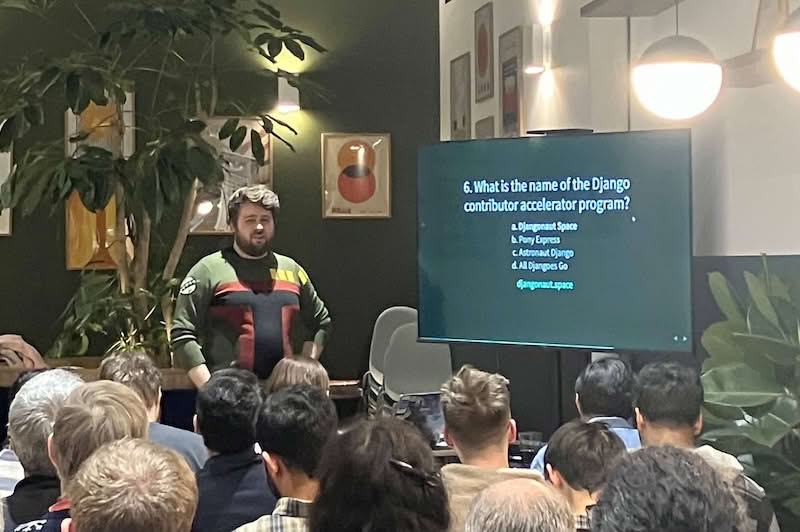 Django London quiz with Adam presenting, and meetup audience in the foreground