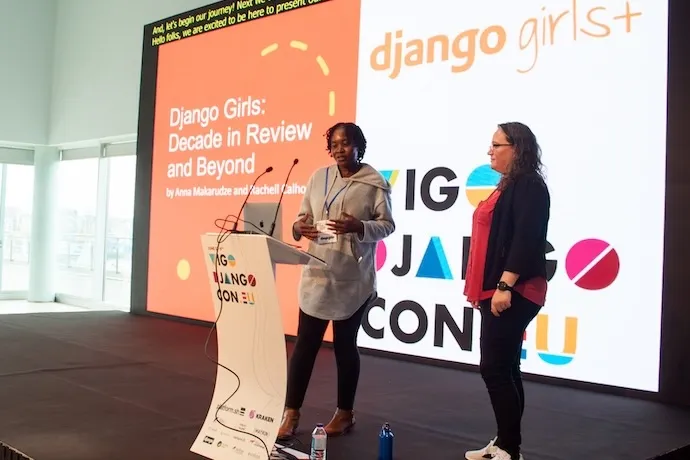 Anna and Rachell on stage, in front of a slide that reads 'Django Girls: Decade in Review and Beyond'